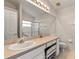 Well-lit bathroom features a large mirror, ample counter space, neutral colors, and walk in shower at 3785 Avon Ct, Clermont, FL 34711