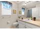 Well-lit bathroom features a vanity with generous counter space and a shower with glass doors at 3785 Avon Ct, Clermont, FL 34711