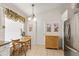 Bright breakfast nook features a table, natural light, and neutral walls, with a stainless steel refrigerator nearby at 3785 Avon Ct, Clermont, FL 34711