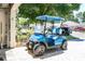 Bright blue golf cart with custom rims on a brick paver driveway at 3785 Avon Ct, Clermont, FL 34711