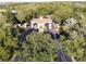 Aerial view of the gated community entrance featuring a red tile roof and lush landscaping at 3785 Avon Ct, Clermont, FL 34711