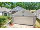 Charming home exterior featuring a two-car garage and well-maintained landscaping in a desirable neighborhood at 3785 Avon Ct, Clermont, FL 34711
