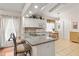 Bright kitchen features granite countertops, an eat-in bar, tile backsplash and white cabinets at 3785 Avon Ct, Clermont, FL 34711