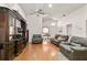 Spacious living room features wood floors, high ceilings, comfortable seating, and a large entertainment center at 3785 Avon Ct, Clermont, FL 34711