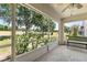 Screened-in porch with a view of the greenery and a comfortable seating area at 3785 Avon Ct, Clermont, FL 34711