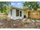 Quaint backyard featuring privacy fence and white exterior of the home at 3972 Poinsettia Ave, Mount Dora, FL 32757