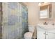 Cozy bathroom featuring a shower with tub, single vanity, and blue-themed shower curtain at 3972 Poinsettia Ave, Mount Dora, FL 32757