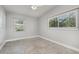 Comfortable bedroom features carpeted floors and natural light from the windows at 3972 Poinsettia Ave, Mount Dora, FL 32757