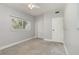 This neutrally painted bedroom features carpeted floors and a closet at 3972 Poinsettia Ave, Mount Dora, FL 32757