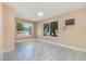Bright bedroom featuring tile flooring, two windows with blinds, and neutral-toned walls at 3972 Poinsettia Ave, Mount Dora, FL 32757
