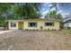 Charming single-story home with yellow paint, green shutters, and landscaped front yard at 3972 Poinsettia Ave, Mount Dora, FL 32757