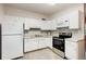 Well-lit kitchen with white cabinets, modern appliances, and stylish marble backsplash at 3972 Poinsettia Ave, Mount Dora, FL 32757