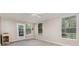 Cozy living room featuring carpeted floors and natural light from the windows at 3972 Poinsettia Ave, Mount Dora, FL 32757