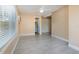Bright, neutral living area featuring tile floors, ceiling fan, and entry to bathroom with single vanity at 3972 Poinsettia Ave, Mount Dora, FL 32757