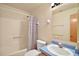 This bathroom features a shower with patterned curtain, toilet, sink, and vanity at 40325 Emeralda Island Rd, Leesburg, FL 34788