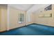 Bright bedroom with vaulted ceiling, multiple windows, and blue carpet at 40325 Emeralda Island Rd, Leesburg, FL 34788