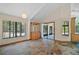 Inviting dining area featuring stone floors, large windows, and a built-in china cabinet at 40325 Emeralda Island Rd, Leesburg, FL 34788