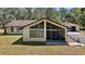 Lovely exterior of home with a screened porch and two-car detached garage at 40325 Emeralda Island Rd, Leesburg, FL 34788