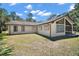Well-maintained home features large windows and a spacious yard, perfect for outdoor enjoyment at 40325 Emeralda Island Rd, Leesburg, FL 34788