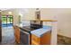 Kitchen features an electric range and blue countertops at 40325 Emeralda Island Rd, Leesburg, FL 34788