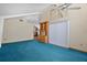 Spacious room featuring high ceilings, built-in cabinet, and comfortable carpeting at 40325 Emeralda Island Rd, Leesburg, FL 34788