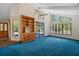 Bright living room featuring high ceilings, large windows, and a built-in cabinet at 40325 Emeralda Island Rd, Leesburg, FL 34788