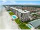 A stunning aerial view of a beachfront condo with lush landscaping and a pool at 4435 S Atlantic Ave # 114, Ponce Inlet, FL 32127