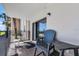 Balcony with seating and a view of the ocean and nearby palm trees at 4435 S Atlantic Ave # 114, Ponce Inlet, FL 32127