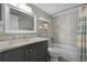 Bathroom features a modern vanity, a shower and tub combination, and open shelving at 4435 S Atlantic Ave # 114, Ponce Inlet, FL 32127