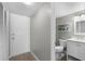 Bright bathroom features a shower, floating shelves with towels, and a white vanity at 4435 S Atlantic Ave # 114, Ponce Inlet, FL 32127