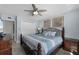 Bedroom with ceiling fan, wood-look flooring, beach-themed decor, and large closet at 4435 S Atlantic Ave # 114, Ponce Inlet, FL 32127