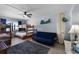 Comfortable bedroom with bunk beds, futon, and surfboard decor, perfect for relaxation at 4435 S Atlantic Ave # 114, Ponce Inlet, FL 32127