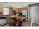 Open kitchen and dining area with tiled floors, wood cabinets, and functional appliances at 4435 S Atlantic Ave # 114, Ponce Inlet, FL 32127