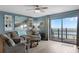 Comfortable living room featuring ocean view, decor, and a ceiling fan at 4435 S Atlantic Ave # 114, Ponce Inlet, FL 32127
