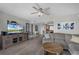 Well-lit living room with modern furnishings, tiled floor, and adjacent kitchen area at 4435 S Atlantic Ave # 114, Ponce Inlet, FL 32127