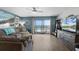 Comfortable living area with stylish decor, ocean view, and access to a private balcony at 4435 S Atlantic Ave # 114, Ponce Inlet, FL 32127