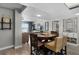 Cozy living space with dining area, TV, and decor, leading to a balcony overlooking the beach at 4435 S Atlantic Ave # 114, Ponce Inlet, FL 32127