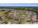 Wide aerial view of a community with a golf course, picturesque ponds, and lush greenery at 4671 Spring Grove Ln, Leesburg, FL 34748