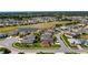 Expansive aerial view of a residential neighborhood with a pond and golf course at 4671 Spring Grove Ln, Leesburg, FL 34748