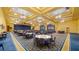 Expansive ballroom with elegant lighting, a stage, and many tables and chairs for events at 4671 Spring Grove Ln, Leesburg, FL 34748