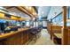 Spacious bar area featuring wooden counters, comfortable seating, and a well-stocked display of glassware and beverages at 4671 Spring Grove Ln, Leesburg, FL 34748