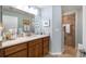 Bathroom with wood vanity and shower, offering style and functionality at 4671 Spring Grove Ln, Leesburg, FL 34748