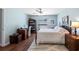 Comfortable bedroom featuring wood floors, ceiling fan, and plenty of natural light at 4671 Spring Grove Ln, Leesburg, FL 34748