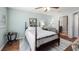 Comfortable bedroom features a four-poster bed, with a ceiling fan and a cozy chair creating a relaxing space at 4671 Spring Grove Ln, Leesburg, FL 34748