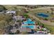 Aerial image of a large community pool area with palm trees, sun loungers and cabanas at 4671 Spring Grove Ln, Leesburg, FL 34748
