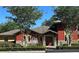 Community Activity Center entrance featuring lush greenery, stone accents, and clear signage at 4671 Spring Grove Ln, Leesburg, FL 34748