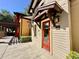 Charming exterior of the community center, showcasing a red entry door and well-maintained landscaping at 4671 Spring Grove Ln, Leesburg, FL 34748