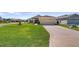 Well-maintained home with lush lawn and mature landscaping at 4671 Spring Grove Ln, Leesburg, FL 34748