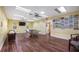 Spacious game room with laminate flooring, ping pong, shuffleboard and ample space for recreation at 4671 Spring Grove Ln, Leesburg, FL 34748