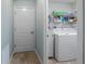 Functional laundry room includes a washer and dryer with storage shelves, providing convenience and organization at 4671 Spring Grove Ln, Leesburg, FL 34748